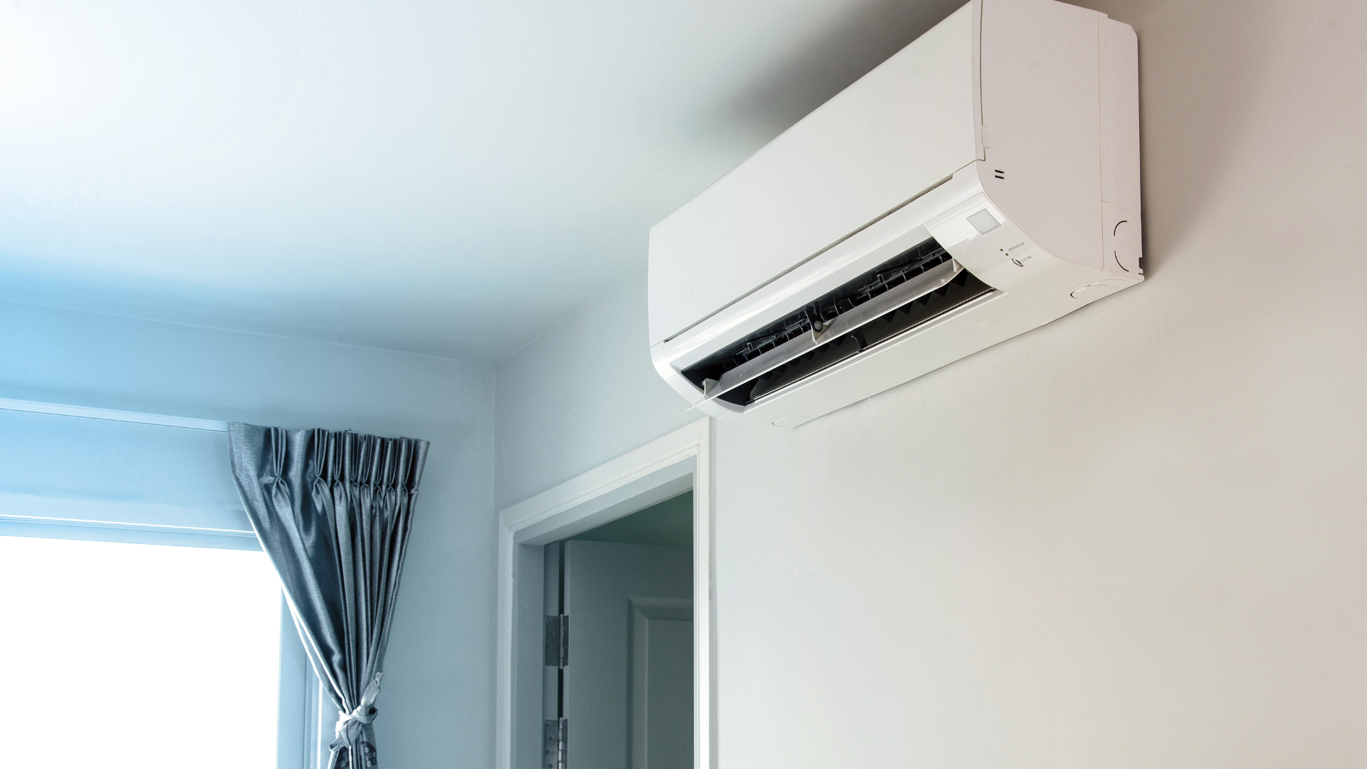 Daikin split system air conditioner mounted on a wall inside a modern home.