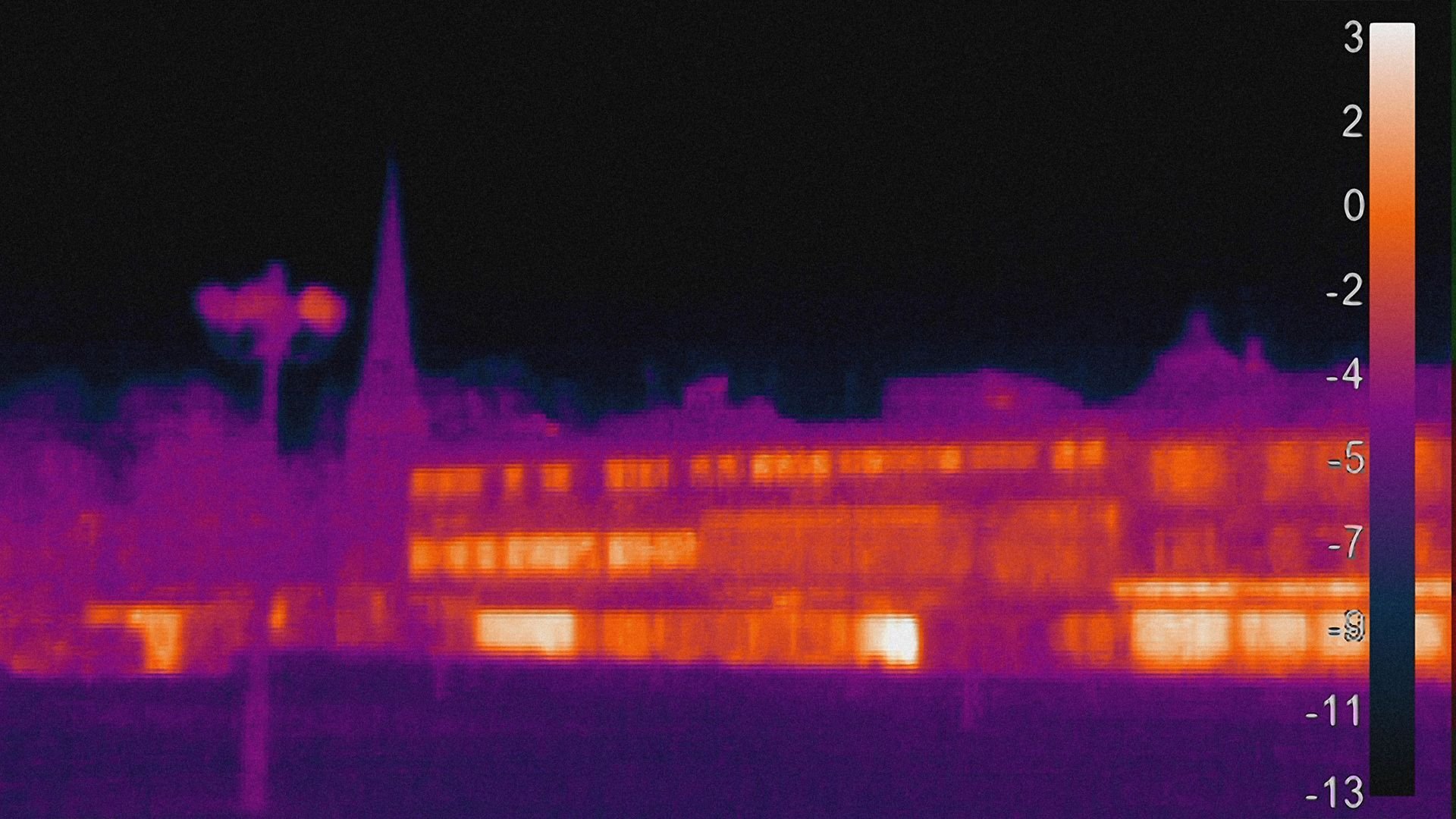 Thermal imaging scan of a building exterior showing heat variations, with warmer areas highlighted in orange and cooler areas in purple