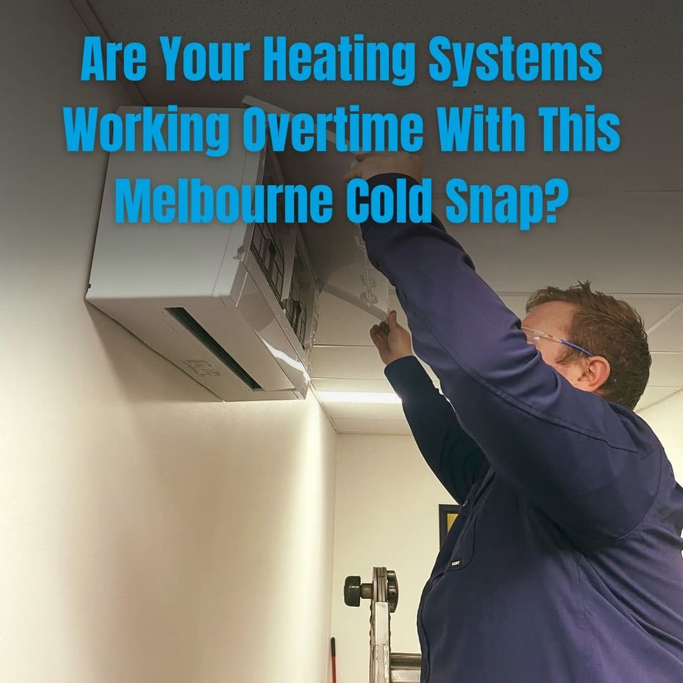 This is an image of a GT HVAC & Electrical technician cleaning the filter of a wall-mounted split system air conditioner during a heating service in Melbourne to improve efficiency and indoor air